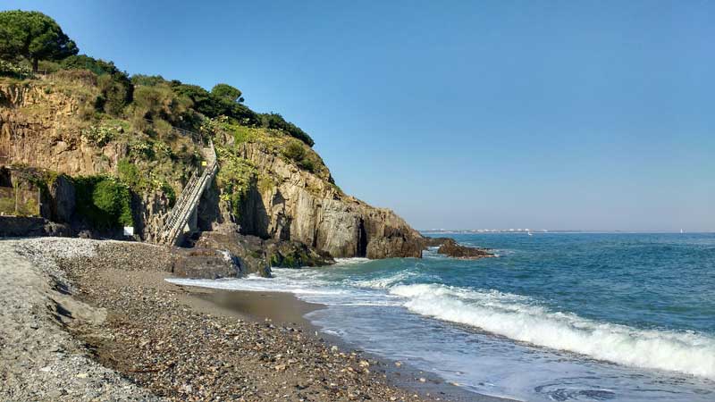 Plage de l'Ouille avec un escalier en bois qui permet de grimper sur les rochers, Argelès-sur-Mer (France)